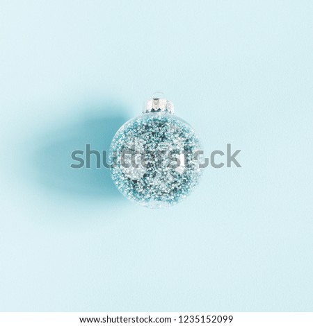 Christmas composition. Christmas ball on pastel blue background. Flat lay, top view, square