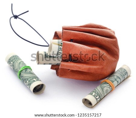 Rolled US Dollar in leather pouch over white background