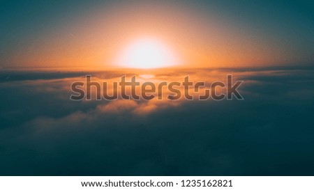 Shot of the sunset with a drone above the clouds