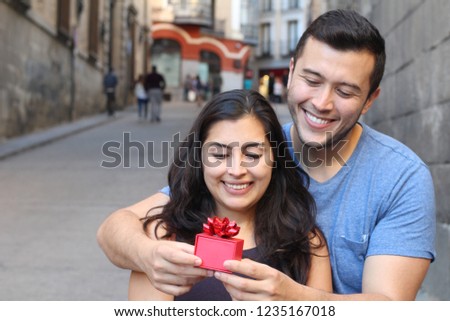 Man giving a present to a gorgeous woman 