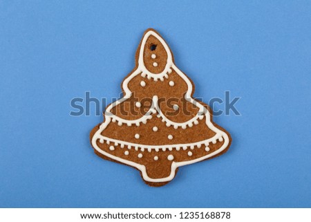 Christmas cookies, gingerbread In the form of a Christmas tree on blue background. Christmas background