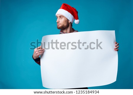 man in christmas hat is holding white mockup                       