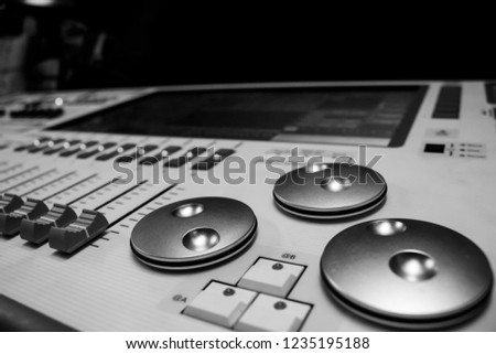 Digital Display and control Faders on Professional Lighting Designers Programming desk, controller Console, white desk and black Faders