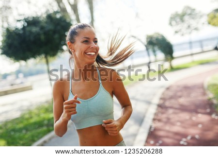 Beautiful sporty urban young woman running outdoor