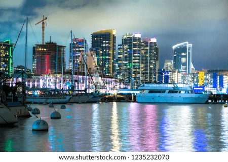 Beautiful San Diego California skyline at harbor seen at night with bay and boats