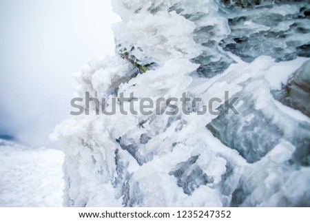 Snowy mountains with deep ravine and rock cliffs