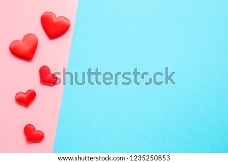 Bright red textile hearts on pastel pink paper. Love concept. Top view. Mockup for positive idea. Empty place for lovely, emotional, sentimental text, quote or sayings on blue background.
