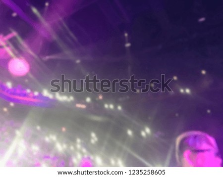 Blurred abstract audience at Asian music show performance in American casino theatre. Defocused concert on stage background
