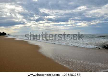 Sea waves on sand beach and blue sky. selective focus.