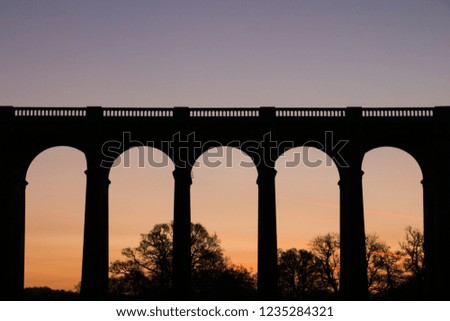 The viaduct across the country valley In the bright morning sun. This historic landmark made for a lovely image