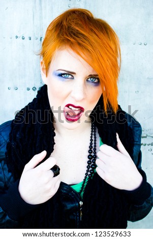 Redhead woman with orange hair against gray background