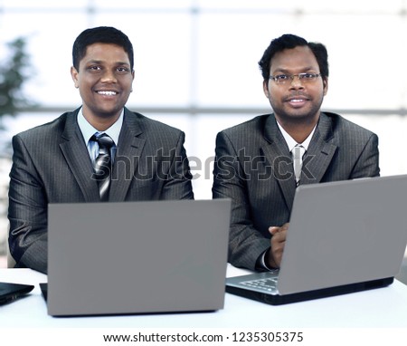 Interracial business team working at laptop in a modern office