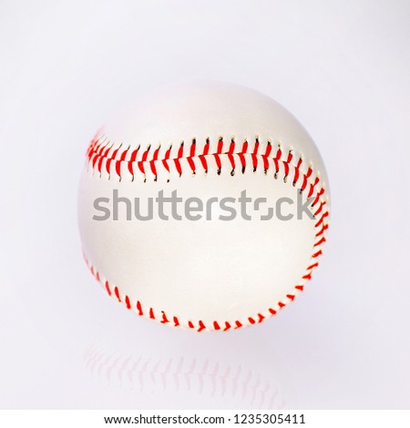 baseball ball with red firmware on the table with reflection