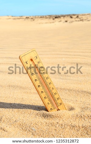 Conceptual Photo Picture of a Thermometer Object in the Dry Desert