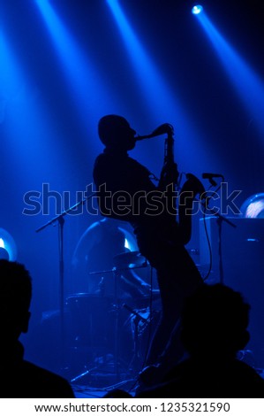 Silhouette of a rock band members playing live.