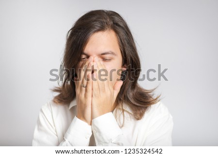 Depressed businessman. handsome business man with nose pain, long haired isolated on background