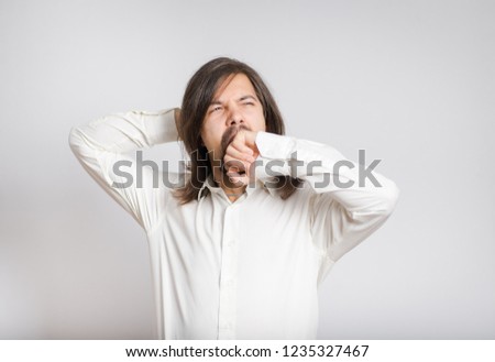 handsome business man yawns long-haired isolated on background