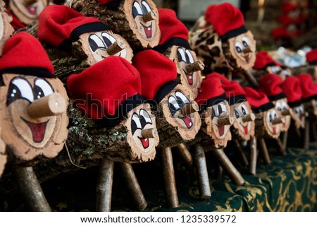 some handmade tio de nadal, a typical christmas character of catalonia, spain, on sale in a christmas market Royalty-Free Stock Photo #1235339572