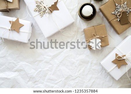 Christmas handmade gift boxes on white crumpled background top view. Merry Christmas greeting card, frame. Winter xmas holiday theme. Happy New Year. Flat lay