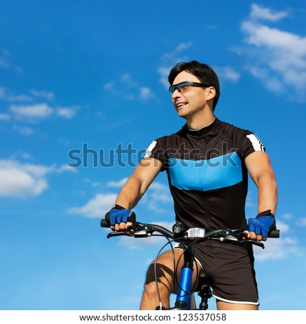 Man Riding a Bike on Blue Sky Background