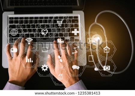  Medical doctor hand working with smart phone,digital tablet computer,stethoscope on black desk,virtual icons screen. top view

