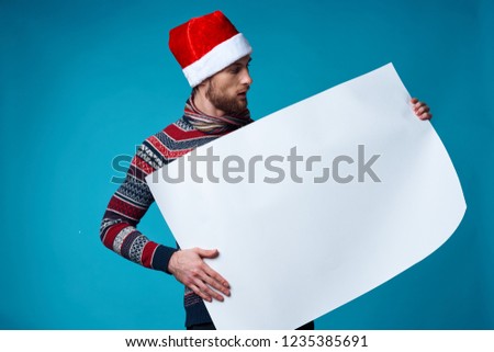 man in christmas hat is holding white mocap               