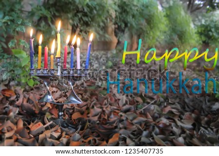 Image for Happy Hanukkah. Hanukkah Menorah in the form of a Jewish star Magen David and Sevivon, Dreidel in Israel. Menorah - candelabrum for Jewish Holiday Hanukkah. Sevivon - Toy of Hanukkah