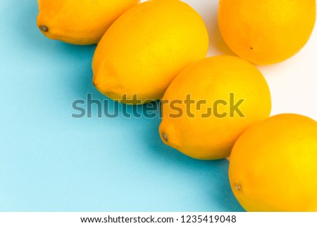 Minimalistic photo of clean lemons on blue-white-red backgrounds