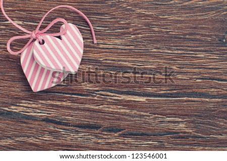 pink hearts on wooden board with pink ribbon