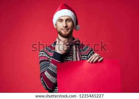 smiling man holding a red mockup                         