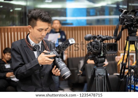 Man photographer checking photo in digital camera and setting. Technological concepts.