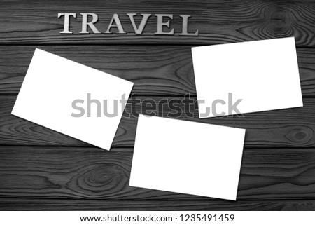 word travel, photo paper on wooden background. photo moments on the trip.