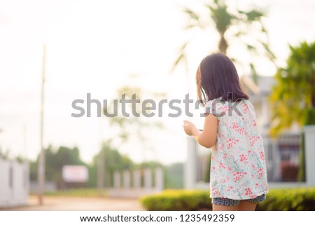 Happy Asian Child girl looking cartoon in smart phone.child, technology and internet concept