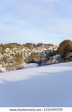 England, Gloucestershire, Cotswolds, winter sunshine on the picturesque village of Bisley under a blanket of snow
