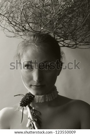 portrait photo of wondering fashion model girl with bush on her head. art monochrome photo