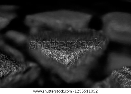 Black and white, monochrome, abstract, minimalistic background, composition of two stones immersed in water with visible texture . Blackness and atmosphere of calmness in zen rocky landscape. 