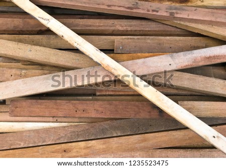 close up pile of square wood stock on the ground