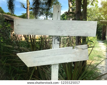 white wooden signboard empty for text with garden background