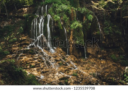 Small mountain waterfall deep in the forest in Serbia, preserve clean water