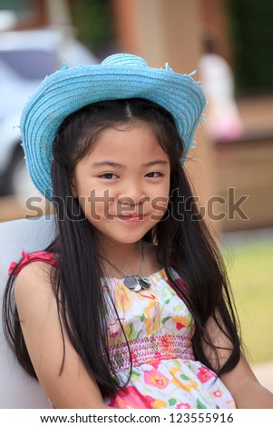 asian girl with long hair wearing blue cowboy hat