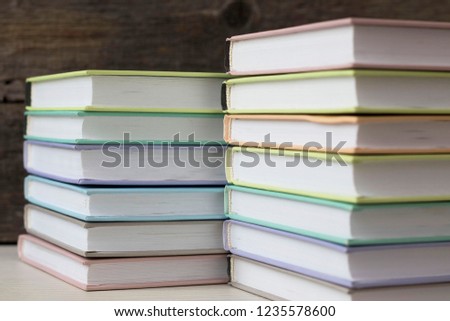 stacks of books on a wooden background