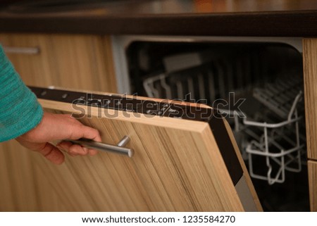 Picture of oven and human hand