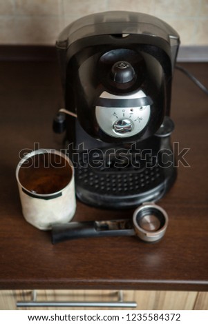 Photo of coffee maker, mug, spoon on table