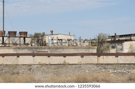 Abandoned buildings of an old industrial factory. Ruins for design background.
