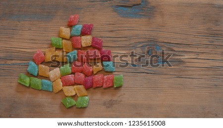 christmas tree shape candy on wooden background