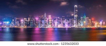 A group of skyscrapers in Hongkong and Kowloon from Victoria harbour viewpoint during night. Place for tourism spot. Beautiful skyline and nice panoramic shore. Can be used for banner