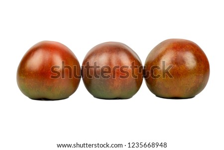 Three fresh kumato tomatoes isolated on white background