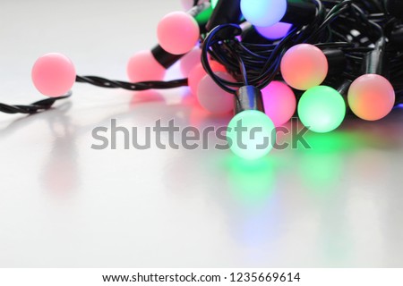 New Year's garland with round little balls shining in different colors. Side view. Place for text.