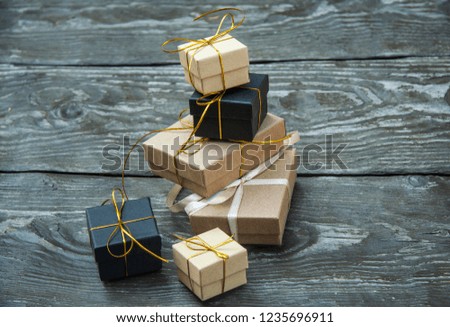 small different Christmas gift boxes on a rustic wooden background