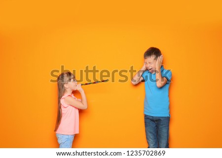 Children celebrating April Fool's day on color background